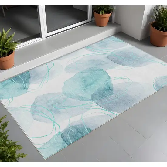 Teal and Ivory Abstract Washable Non Skid Indoor Outdoor Area Rug Photo 1