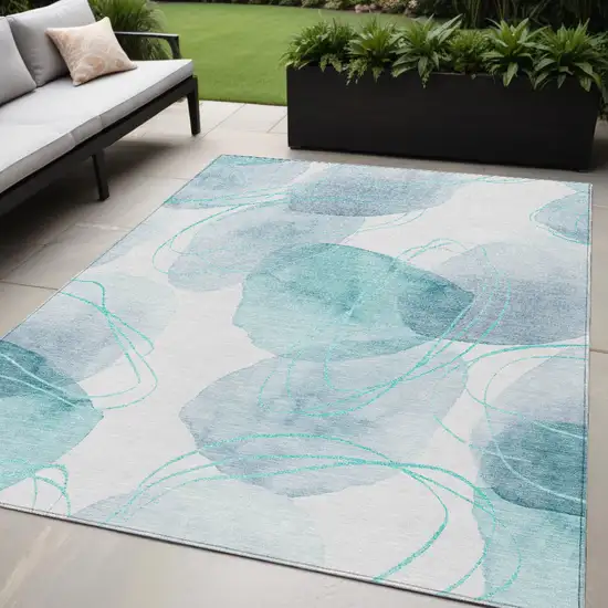 Teal and Ivory Abstract Washable Non Skid Indoor Outdoor Area Rug Photo 1