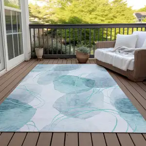 Photo of Teal and Ivory Abstract Washable Non Skid Indoor Outdoor Area Rug