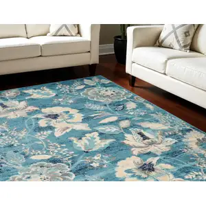 Photo of Turquoise Cream and Navy Blue Floral Distressed Area Rug