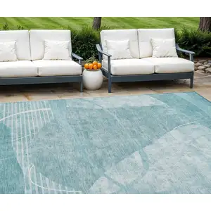 Photo of Turquoise Teal Blue And Ivory Abstract Washable Indoor Outdoor Area Rug