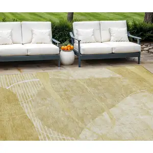 Photo of Wheat Gold And Ivory Abstract Washable Indoor Outdoor Area Rug